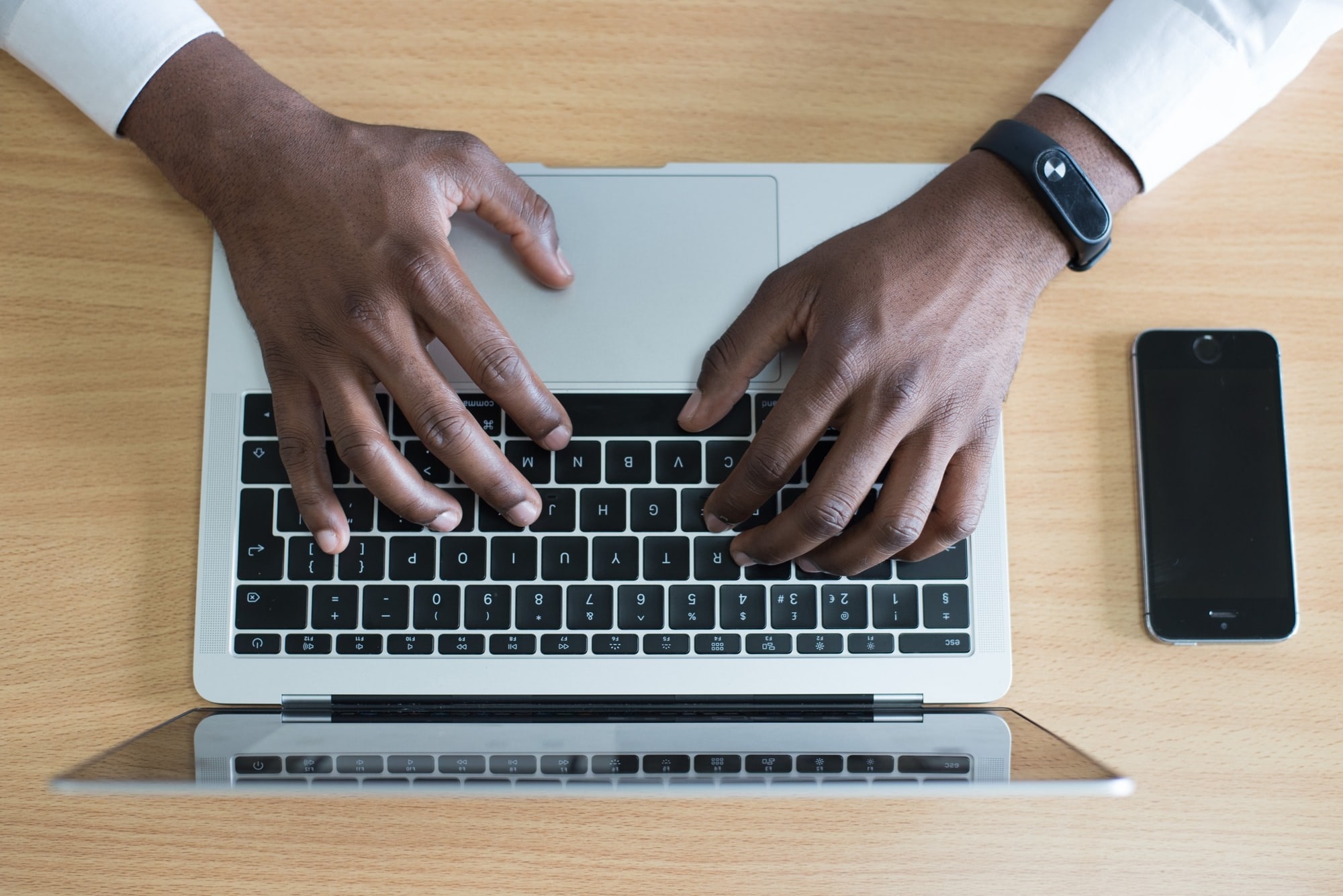 Hands typing on laptop keyboard - Still photo